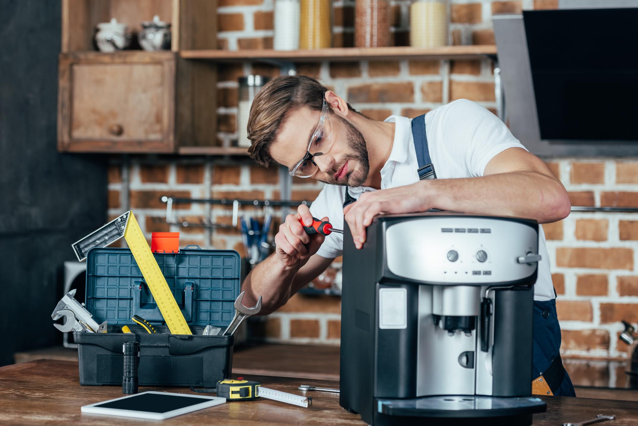 Service technician repairing a coffee machine