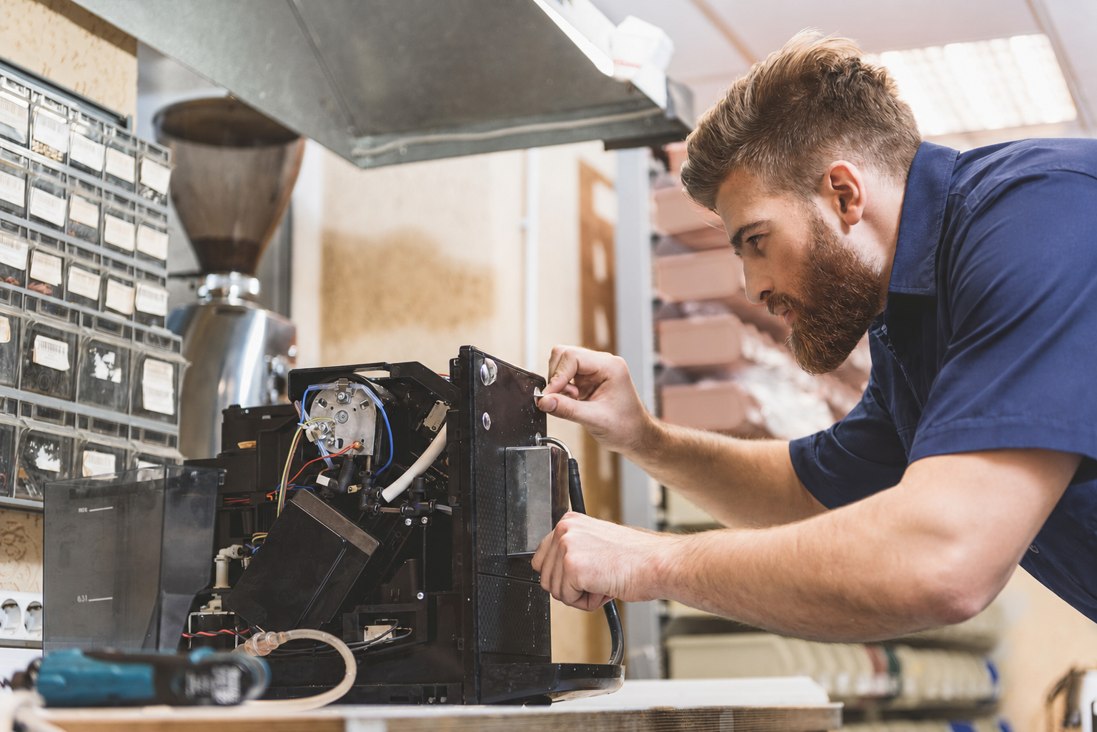 Service technician repairing commercial beverage equipment